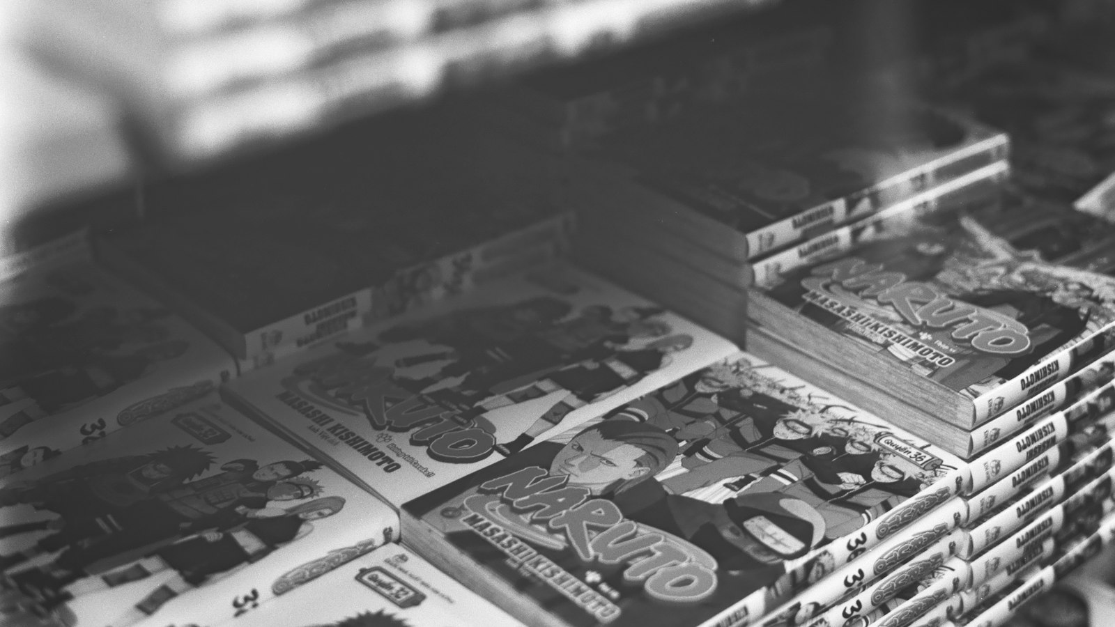Stacks of manga books on a shelf