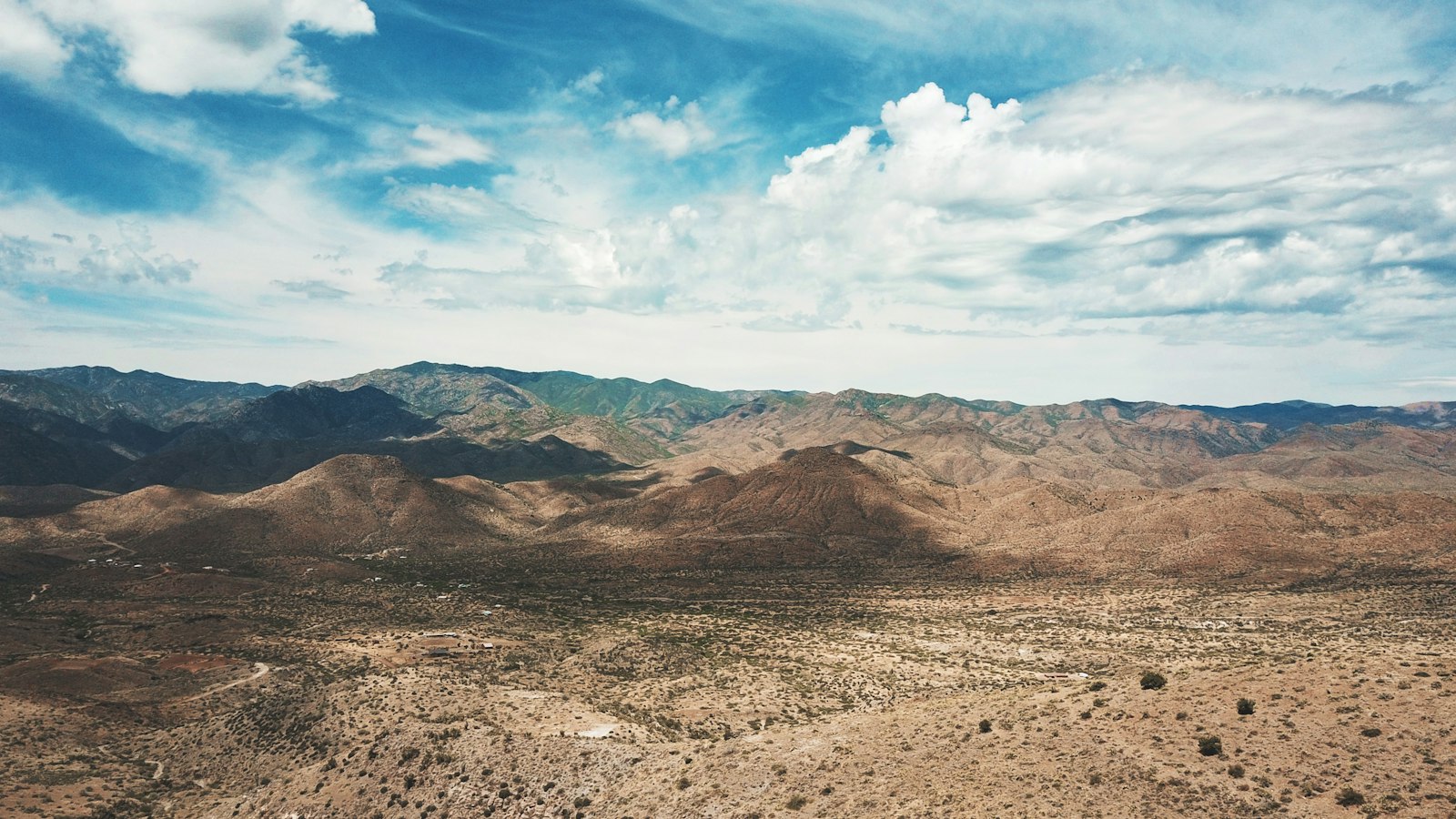 mountain under blue and white skies