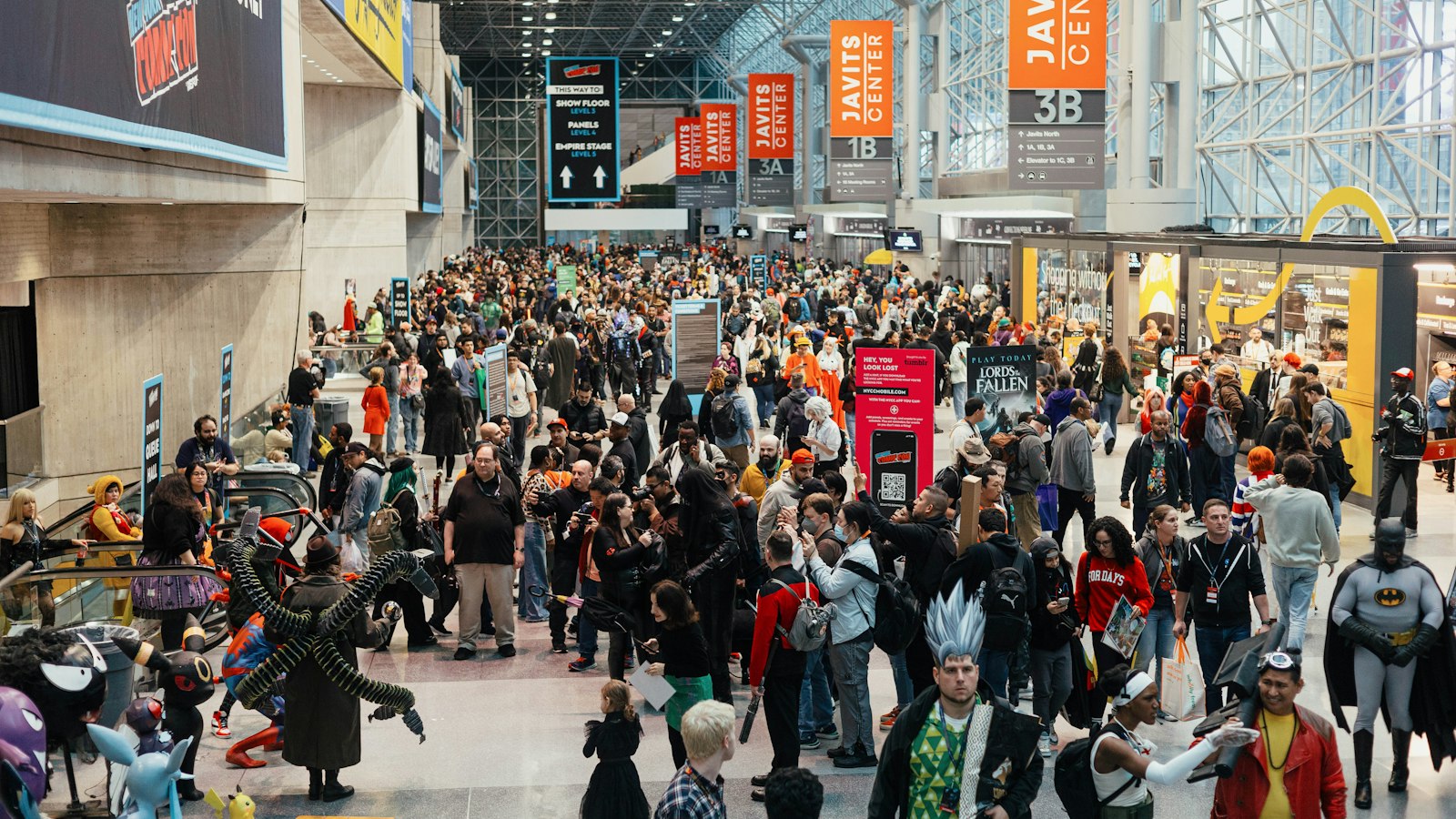 a large group of people walking through an airport